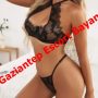 Woman in black lace lingerie posing in a bedroom with bold red text across the image reading 'Gaziantep Escort Bayan'
